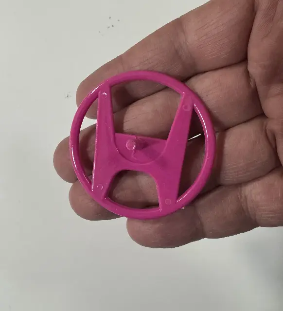 Plastic spinning top from a 3D printer Honda car emblem
