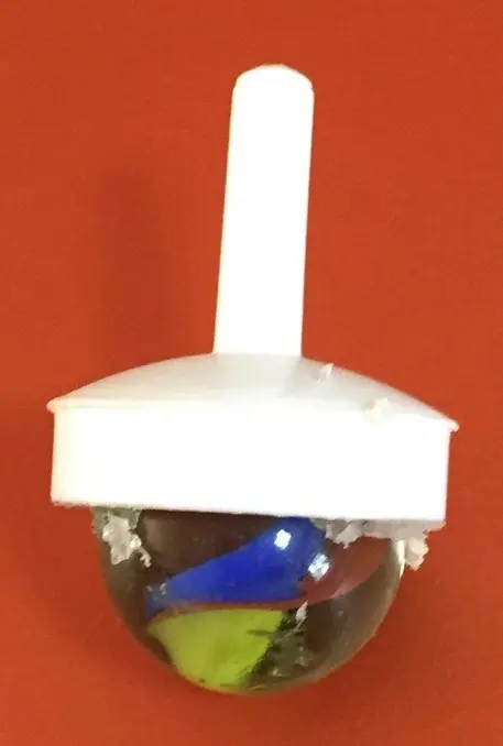 Stone-encrusted spinning top